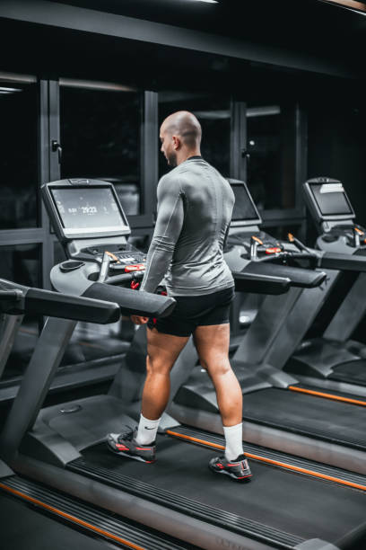 istock Young man using the treadmill in the gym 1797233694