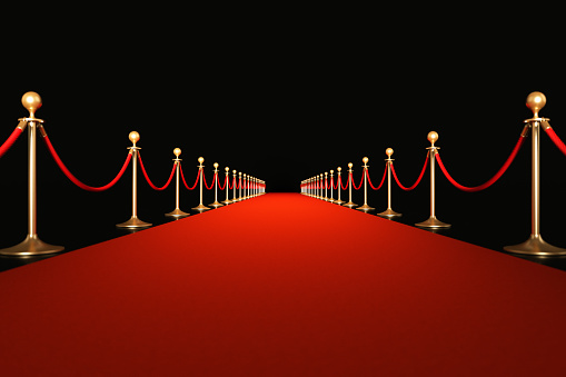 Red carpet on black background. Horizontal composition with copy space. Great use for red carpet related concepts.