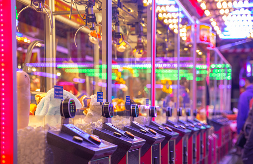 Close-up of a row of claw machines with digital payment, colorful