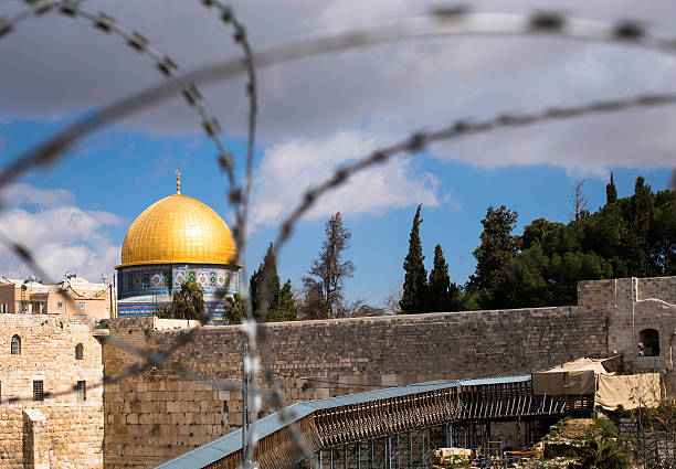 istock Rock Dome in Jerusalem behind wired fence 179725728
