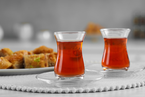 Glasses of traditional Turkish tea on white table indoors