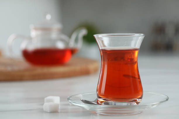 istock Glass of traditional Turkish tea on white marble table, space for text 1797258233