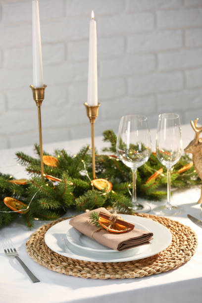 istock Festive place setting with beautiful dishware, fabric napkin and dried orange slice for Christmas dinner on white table 1797258755