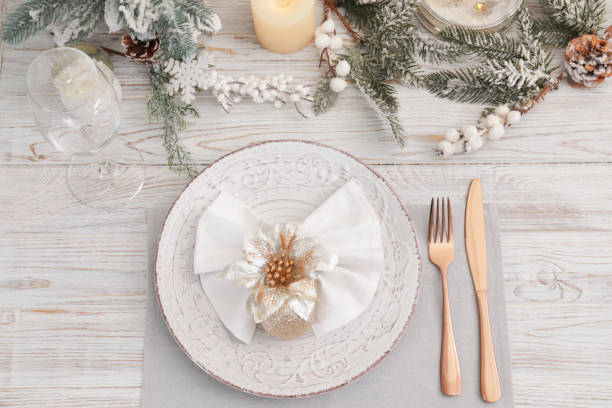 istock Festive place setting with beautiful dishware, cutlery and decor for Christmas dinner on white wooden table, flat lay 1797261546