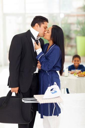 loving husband kissing wife before going to work