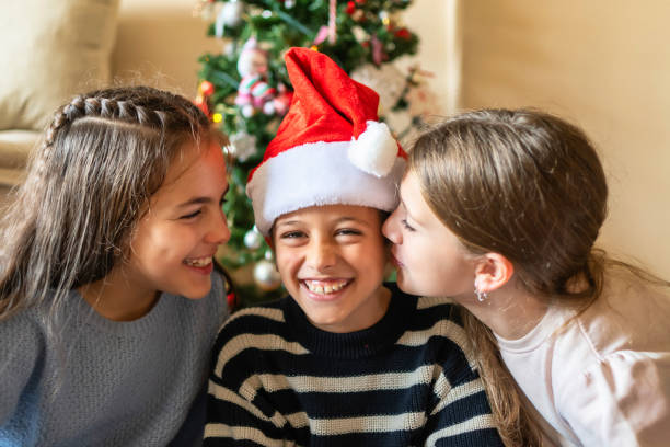 istock 3  Siblings Celebrates Christmas with Hugs and Joy at Home 1797274469