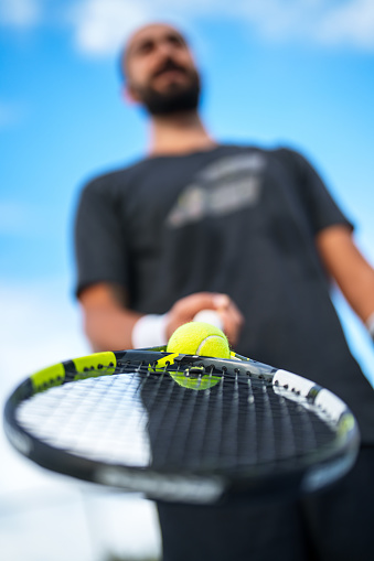Achieve the impossible: Tennis ball is trapped in the neck of the racket.