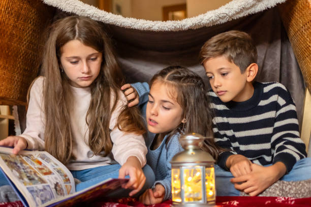 istock Three Little Brothers Enjoying A Story At Home. 1797275002