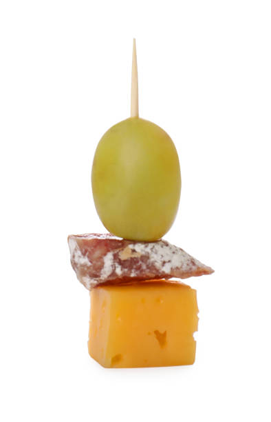 istock Toothpick appetizer. Tasty cheese, sausage and grape on white background 1797286840