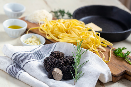 Truffle pasta ingredients on table.