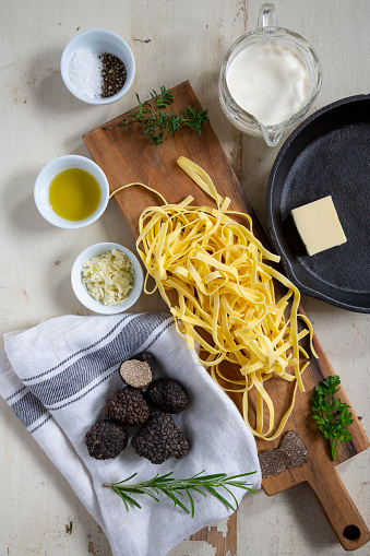 Truffle pasta ingredients on table.