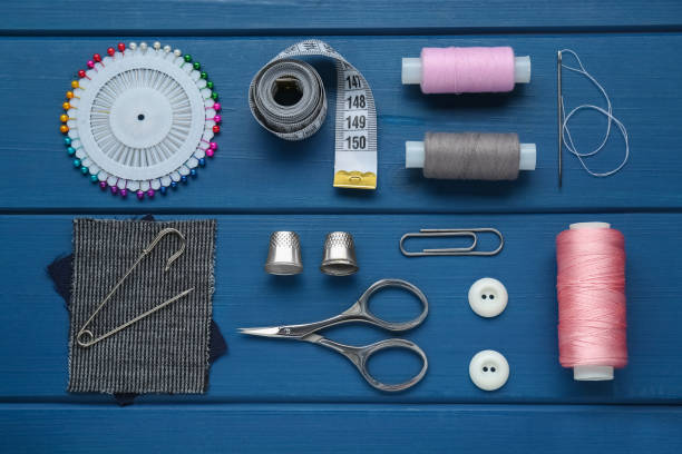istock Flat lay composition with thimbles and different sewing tools on blue wooden table 1797296296
