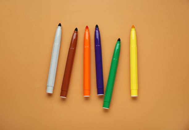istock Different colorful markers on light brown background, flat lay 1797297643