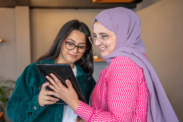 istock Two female colleagues working with laptop and tablet 1797304553