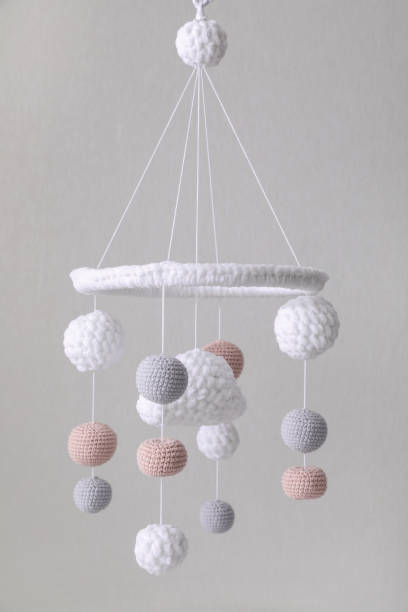 istock Modern baby crib mobile near beige wall in room 1797307777