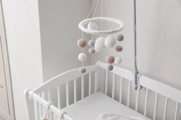 Modern baby mobile under crib in children's room