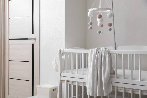 istock Modern crib with baby mobile in children's room. Interior design 1797308040