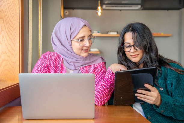 istock Two female colleagues working with laptop and tablet 1797310598