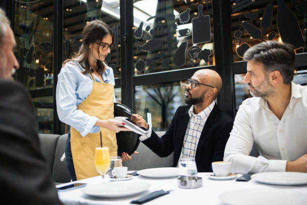 istock Young businessman making a payment for the lunch with clients 1797325478