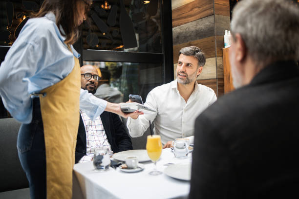 istock Handsome businessman making a payment for the lunch with clients 1797325491