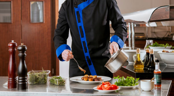 istock Chef preparing the food with sauce in kitchen. 1797370376