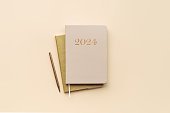 Year 2024 diary planner on a beige background, top view