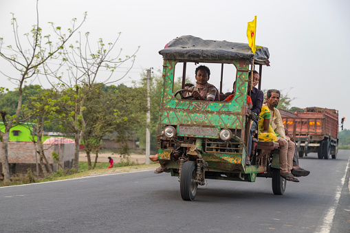 Purbba Goti, West Bengal,India 18 April 2022 A person riding a motorcycle chassis based transport or chakda.This is also called Jugaad gadi.