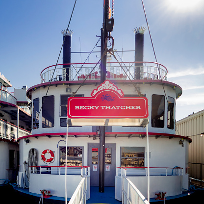 October 22, 2023 - St. Louis, Missouri, USA: Head-on close up of the paddle wheeler Becky Thatcher docked on the Mississippi River at St. Louis. Clear, blue sky, sunshine.
