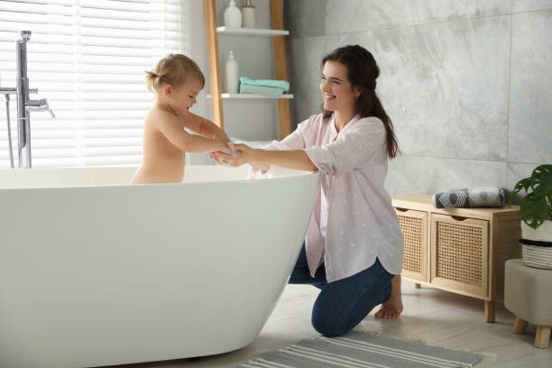 istock Mother with her little daughter in bathroom 1797445320