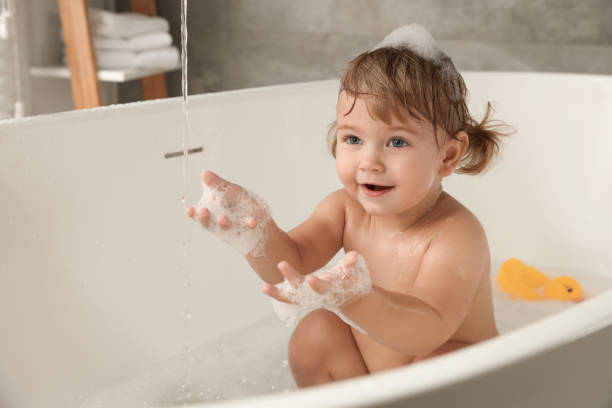 istock Cute little girl taking bubble bath indoors. Space for text 1797446894