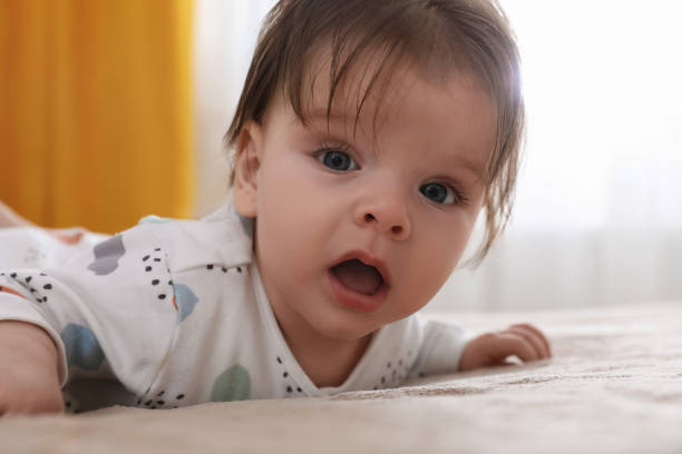 istock Cute little baby on bed at home 1797448495