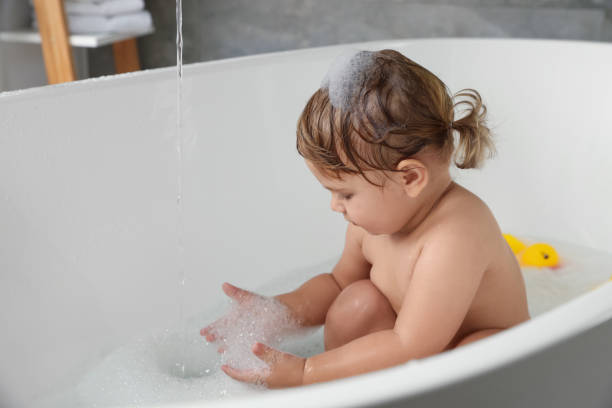 istock Cute little girl taking bubble bath indoors. Space for text 1797449016