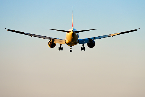 Airplane landing during sunset in Barcelona