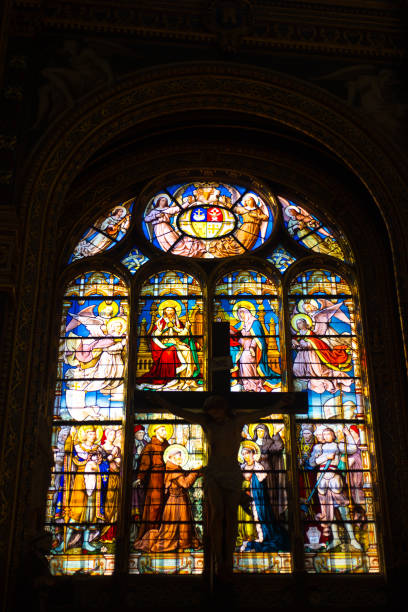 Paris, France: Stained Glass Window Inside Saint-Eustache Church Paris, France: A stained glass window inside the Church of Saint-Eustache, a Gothic structure completed in 1637 and located in the 1st arrondissement. église saint eustache stock pictures, royalty-free photos & images
