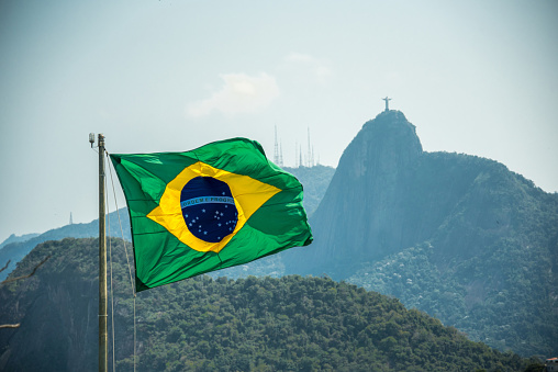 Brazilian flag on a background of Christ the Redeemer