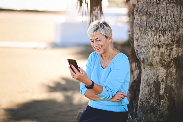 istock Mature elegant woman using mobile phone for video call. 1797466521