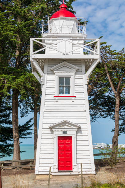 Blackett's Lighthouse, Timaru designed by John Blackett. The row of eleven mature macrocarpa trees gives the lighthouse, a historic building, a nice background and some protection from the elements. It has been moved three times.