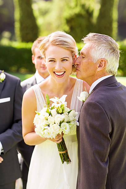 istock Bride Looking Away While Father Kissing Her On Cheek 179748993