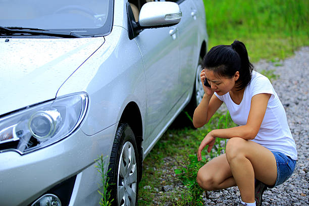 woman driver on the phone calling for help with car problems