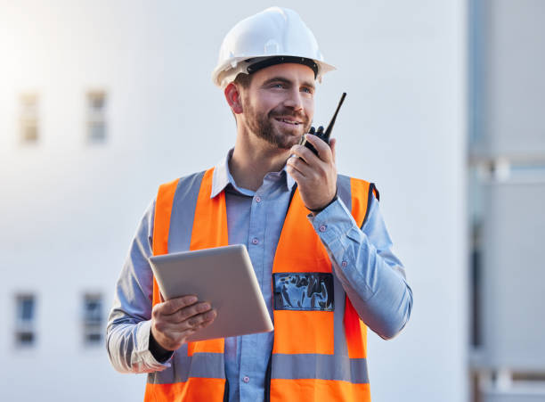 istock Walkie talkie of construction worker man for project management, planning or communication on tablet workflow. Architecture, contractor or happy engineering person with 5g tech for industrial update 1797509269