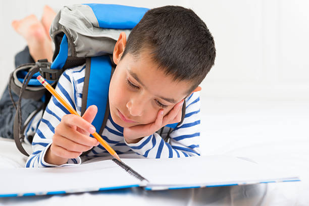 istock Young boy concentrating on his homework 179751570