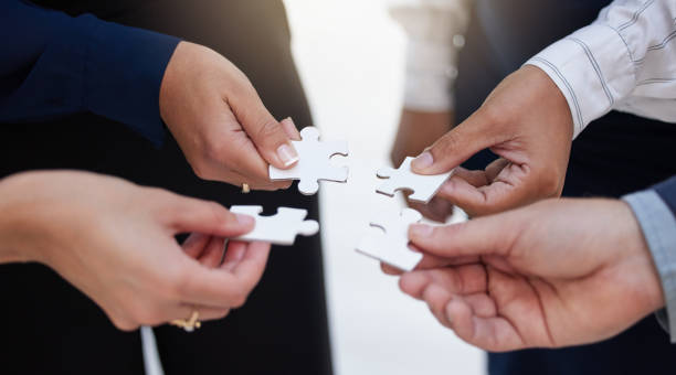 istock Team, hands and puzzle for teamwork, solution and integration, synergy and collaboration. Hand, business people and jigsaw for strategy, support and partnership, innovation and unity in cooperation 1797540609