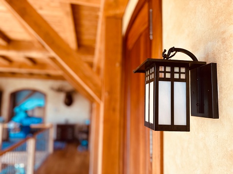 old rusty kerosene lamp and an iron on a stove shelf in an old country house. Traditional rural interior and household objects