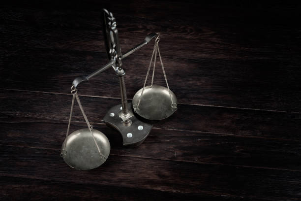 istock Bronze traditional balance scale on wooden table 1797568316