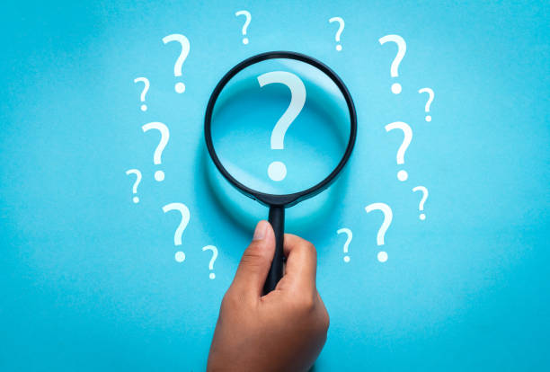 istock hand holding a magnifying glass. question mark icon in magnifying glass 1797573869