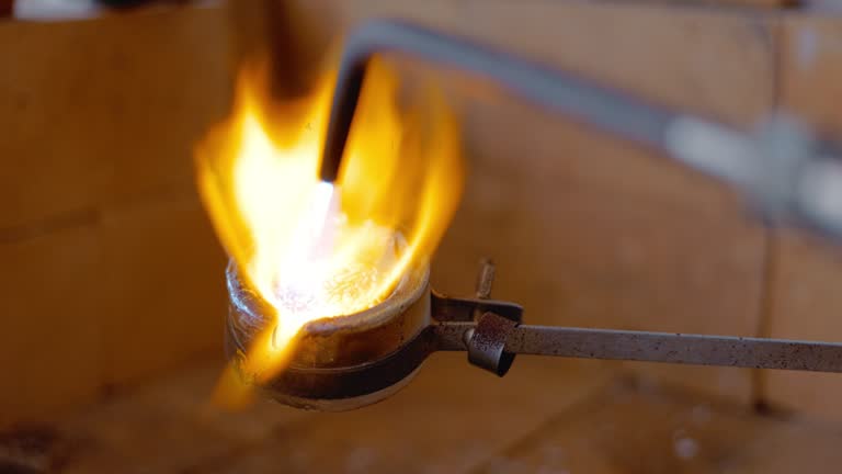 Fire torch , workshop and spark for welding with metal and iron design with handyman production. Blacksmith, welder project and blowtorch with person and employee working on handcraft with steel