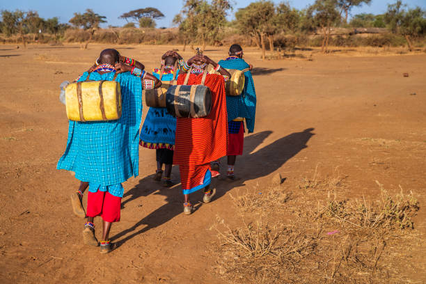 African women from Maasai tribe carrying water, Kenya, East Africa