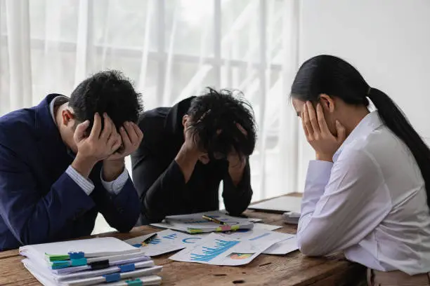 A group of stressed-out young Asian businessmen searching for a solution to a problem at a partnership meeting are left scratching their heads over bad news of a failed attempt. Feeling hopeless about the company's problems
