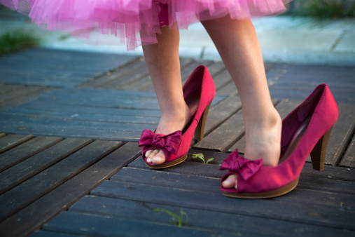 A little girl wearing her mother's high heel shoes (childhood and adolescence) and said : They fit me!!!