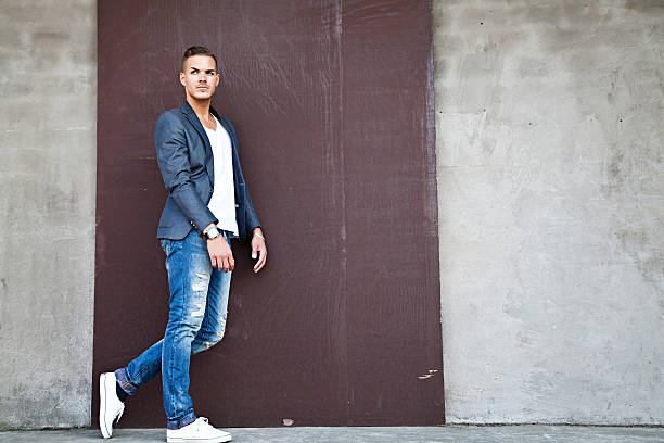 istock beautiful young man outdoors against a wall 179769337